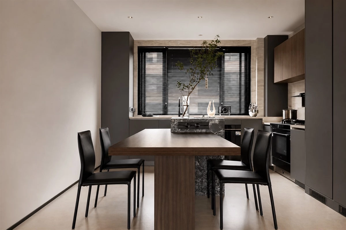 Dark grey and wood apartment kitchen with green marble island