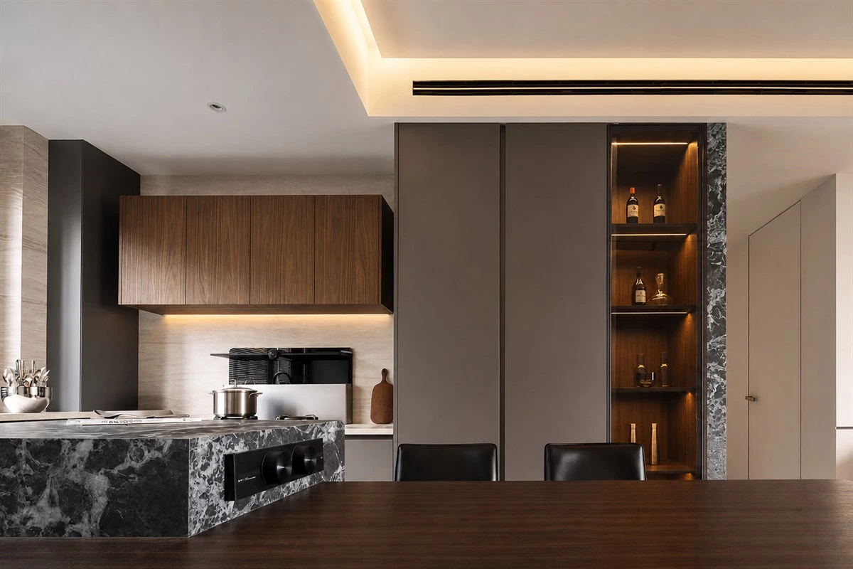 Split-level island in a dark modern apartment kitchen