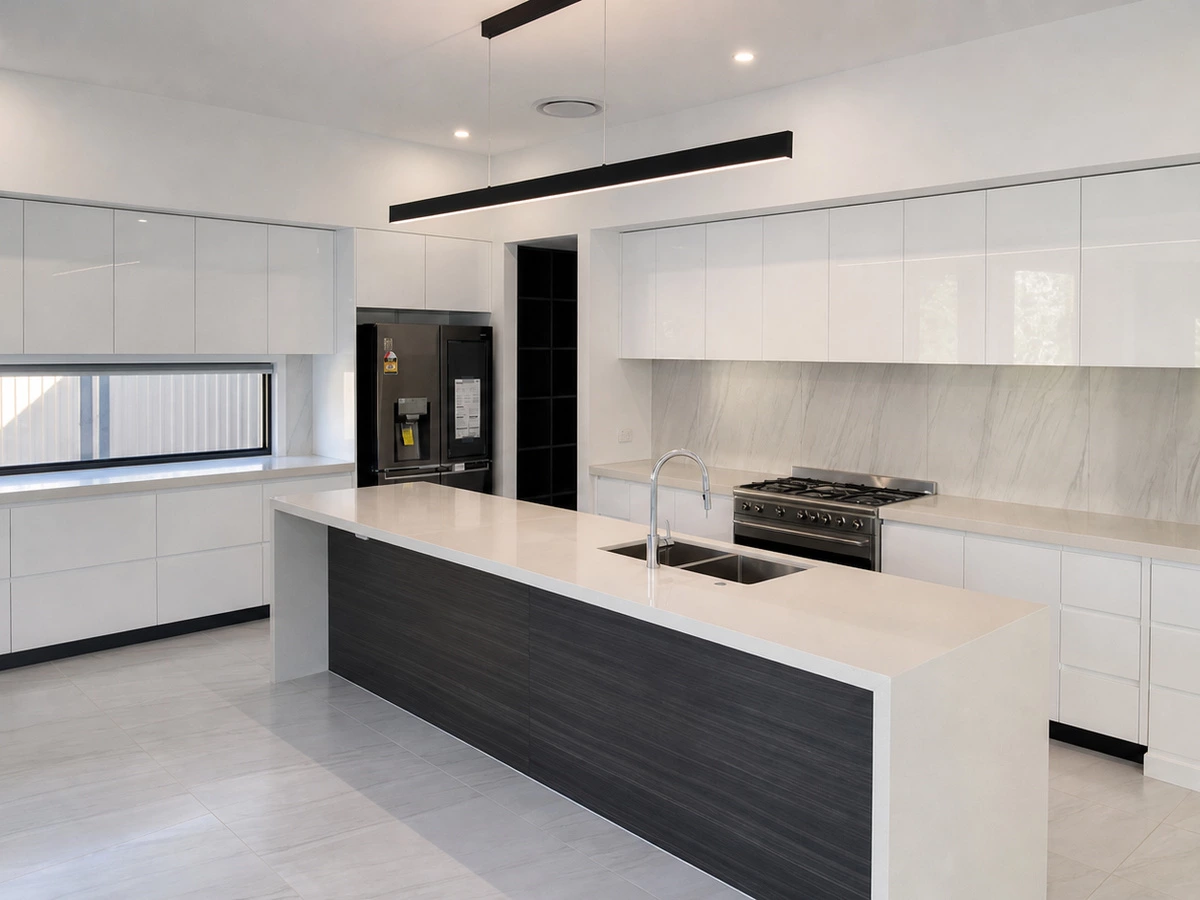 White kitchen units with a textured backsplash and island in the Spain Edin Emperor Villa Project