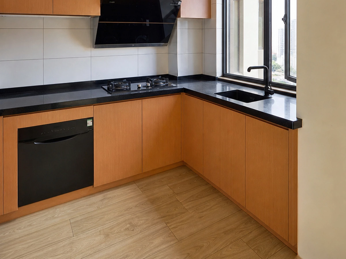 Natural orange wood veneer and black quartz detail in the apartment kitchen