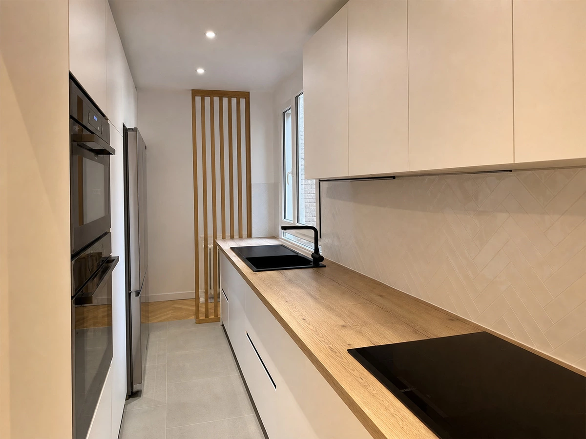 White and wood galley kitchen cabinets with built-in appliances in Melbourne
