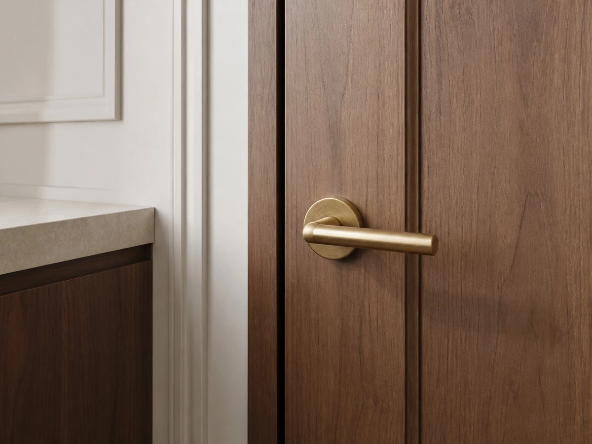 Interior door handle clearance detail near wall panels and cabinets
