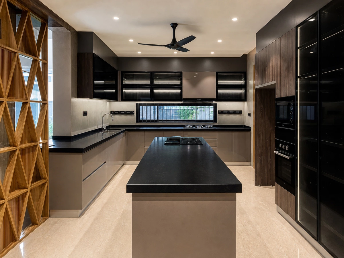 Wide view of a modern India villa kitchen with black glass cabinets