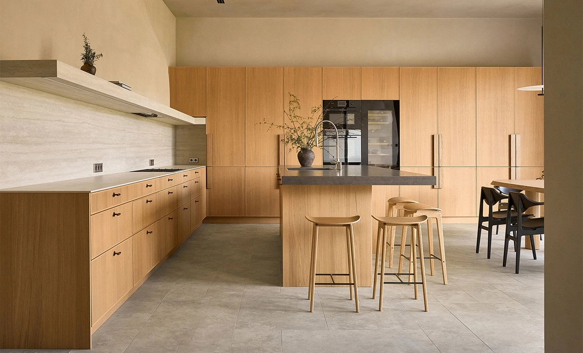 Custom wood cabinets with a light timber kitchen island and bar seating