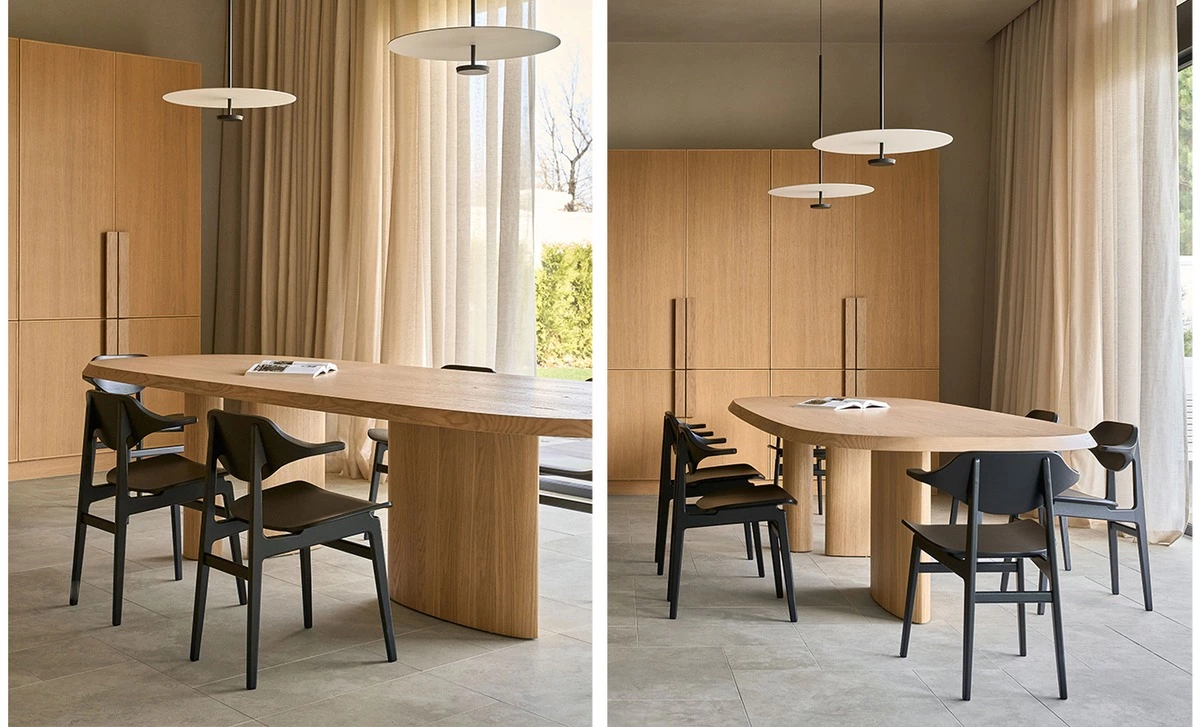 Light timber dining table coordinated with custom wood cabinets