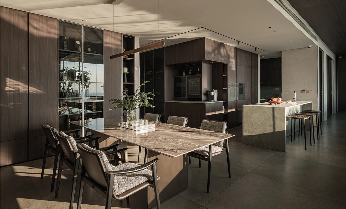 Walnut dining area with custom cabinetry in an open-plan residence