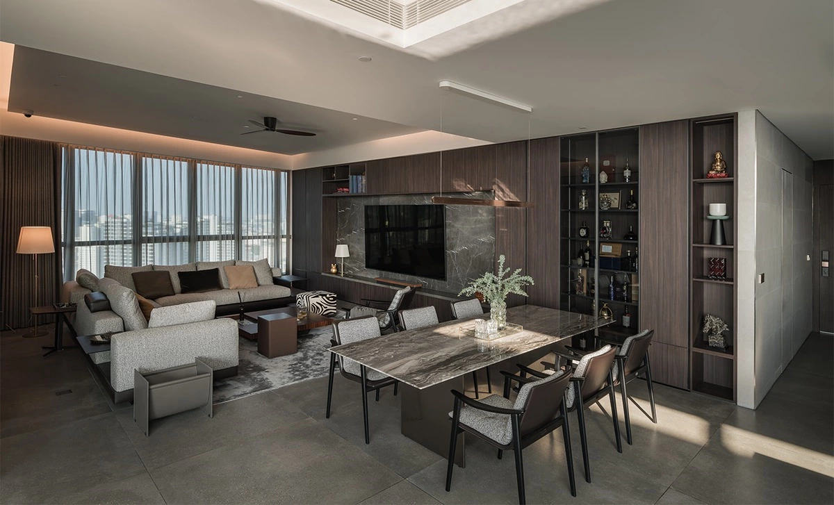 Hotel-inspired walnut cabinetry across an open kitchen dining and living space